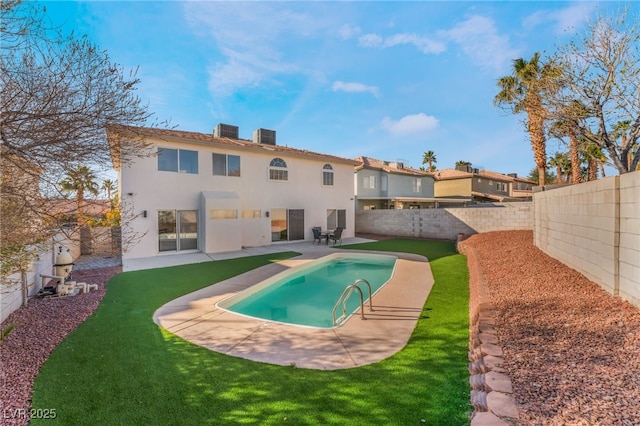 rear view of property with a fenced in pool, a lawn, central AC unit, and a patio area