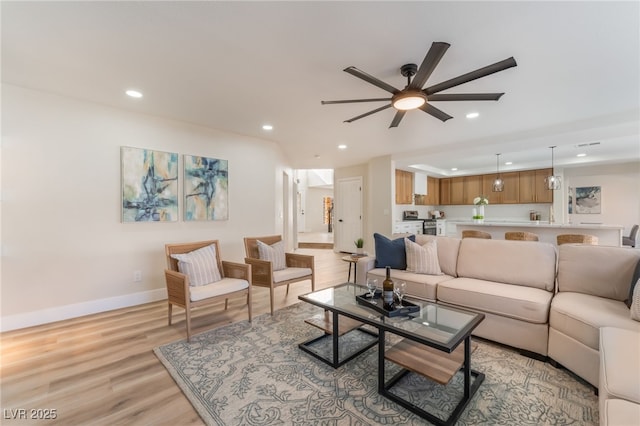 living room featuring ceiling fan and light wood-type flooring