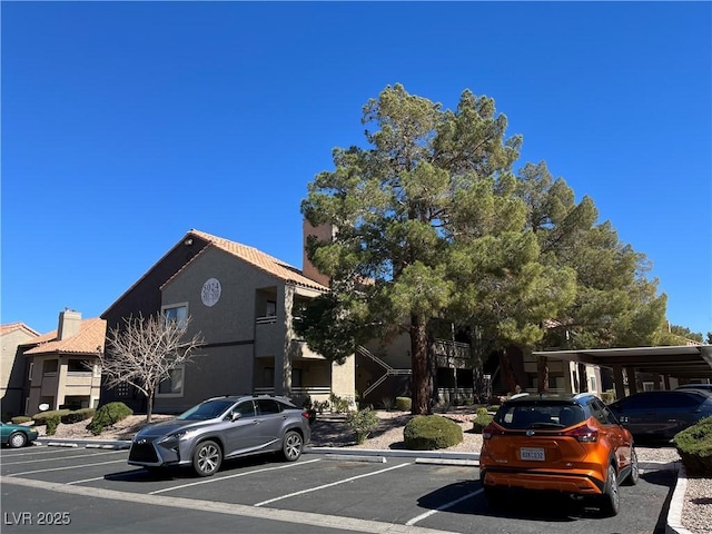 view of parking / parking lot featuring a carport