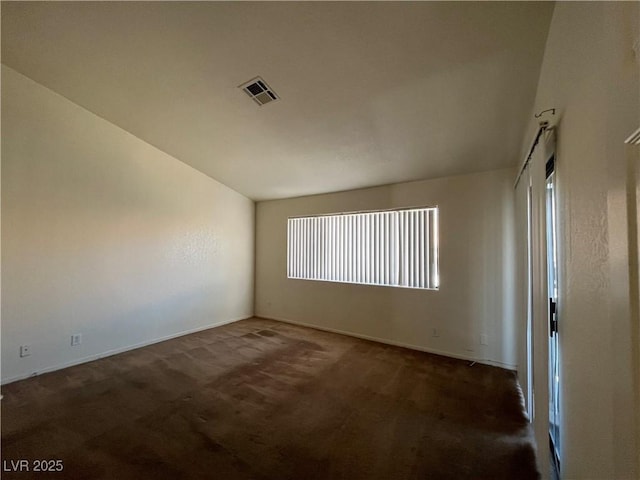 empty room featuring dark carpet