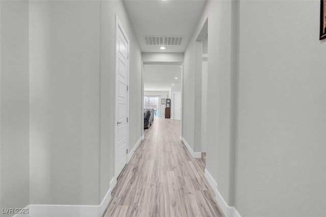 corridor with light wood-type flooring