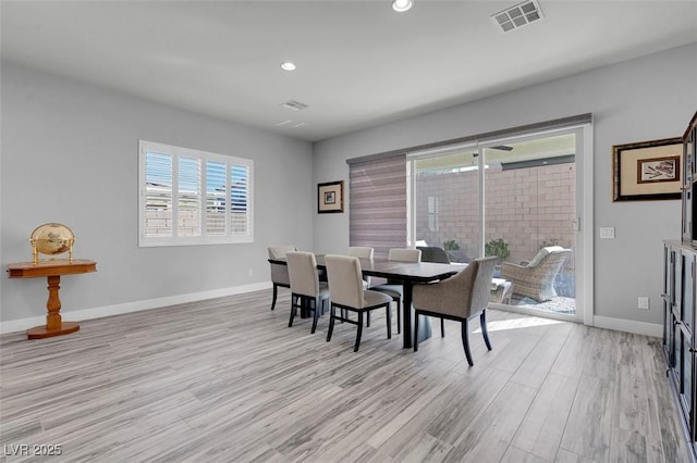 dining area featuring light wood-type flooring