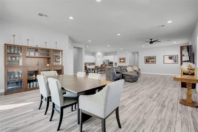 dining room with light hardwood / wood-style flooring and ceiling fan