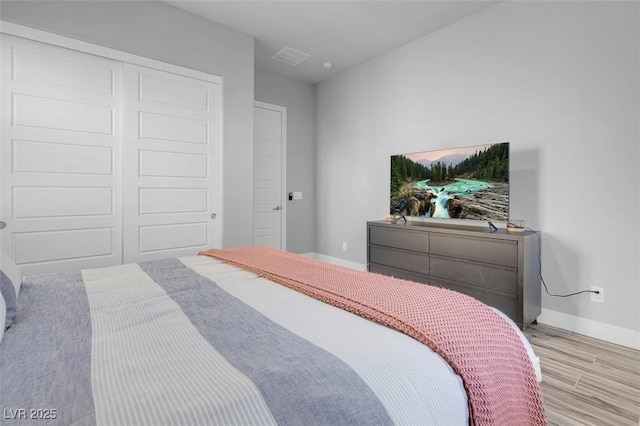 bedroom featuring a closet and light wood-type flooring