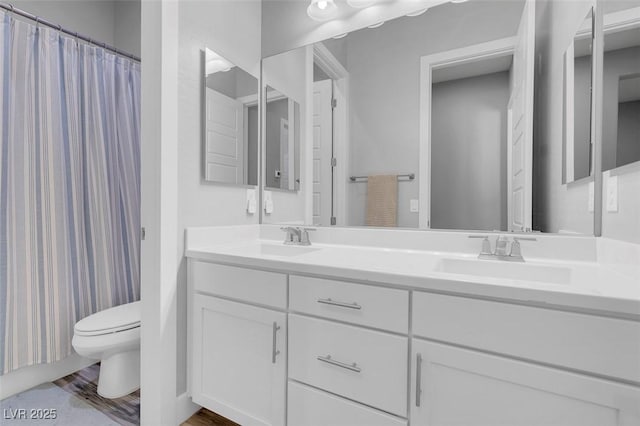 bathroom with hardwood / wood-style flooring, vanity, toilet, and a shower with curtain