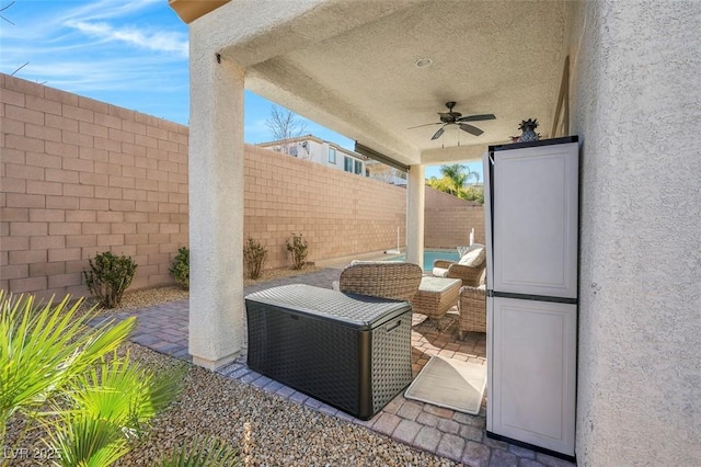 view of patio featuring ceiling fan