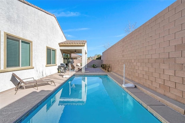 view of pool with a patio and ceiling fan