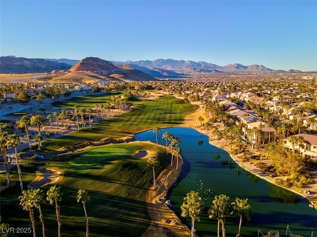 birds eye view of property with a water and mountain view