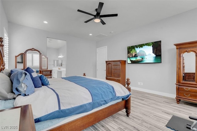 bedroom featuring ceiling fan, connected bathroom, and light hardwood / wood-style flooring