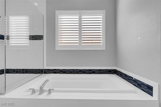 bathroom with tiled bath