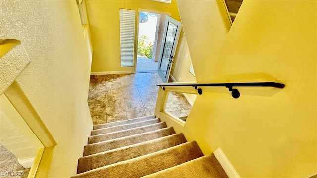 stairway featuring tile patterned flooring