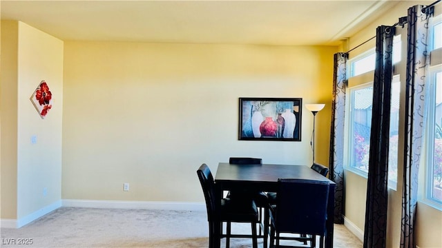 dining area featuring light carpet