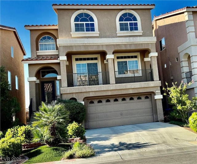 mediterranean / spanish-style home with a garage