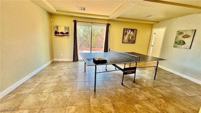 recreation room featuring light tile patterned flooring and coffered ceiling