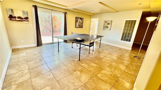 recreation room featuring tile patterned flooring and coffered ceiling