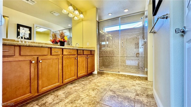 bathroom featuring vanity and an enclosed shower