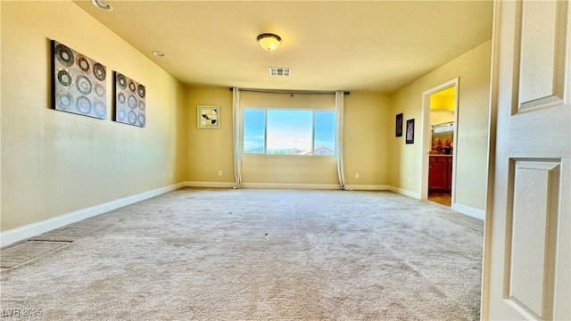 unfurnished room featuring carpet