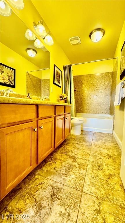 full bathroom featuring vanity, shower / tub combo, and toilet