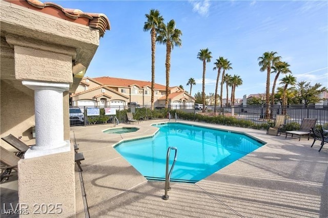 view of swimming pool featuring a patio area and a community hot tub