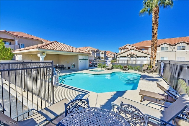 view of pool with a community hot tub and a patio area