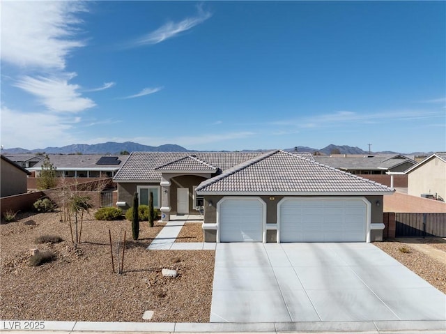 view of front of home with a mountain view and a garage