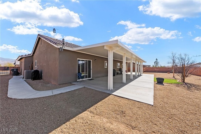 rear view of house featuring cooling unit and a patio area