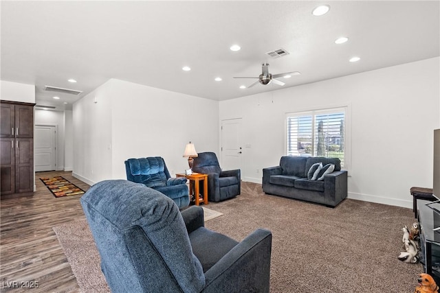 living room with ceiling fan and light wood-type flooring