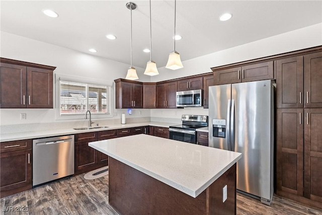 kitchen featuring stainless steel appliances, a kitchen island, sink, and dark brown cabinets