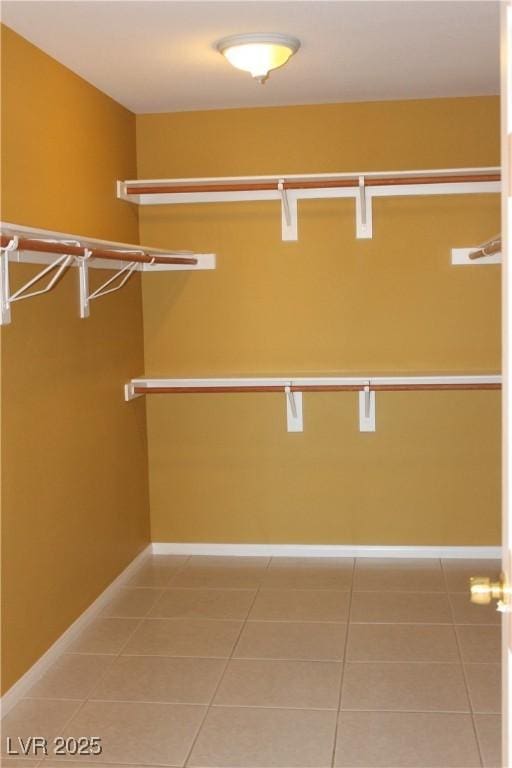 spacious closet with light tile patterned floors