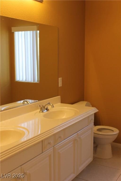 bathroom featuring tile patterned flooring, vanity, and toilet