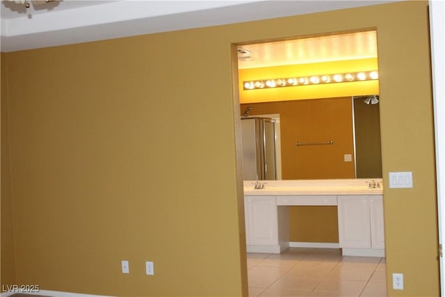 hallway featuring light tile patterned flooring and sink