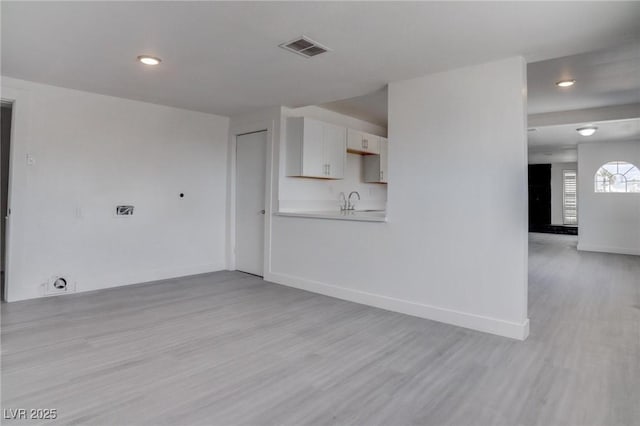 unfurnished living room with light wood-type flooring