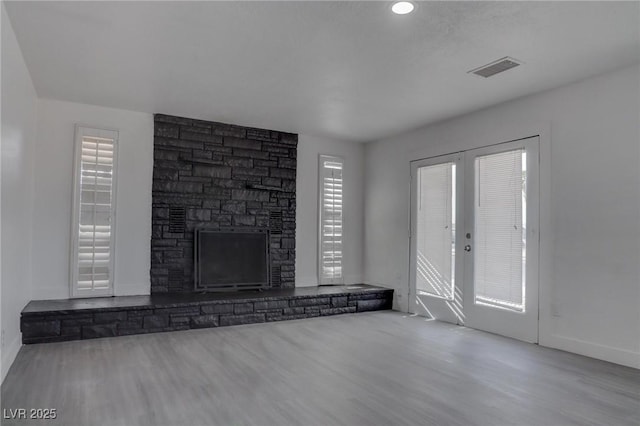 unfurnished living room with a fireplace and light hardwood / wood-style flooring