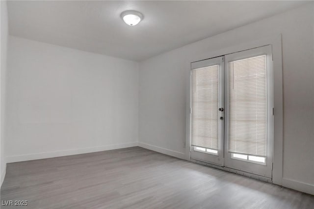 unfurnished room with light wood-type flooring