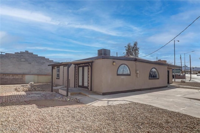 exterior space with cooling unit and a patio