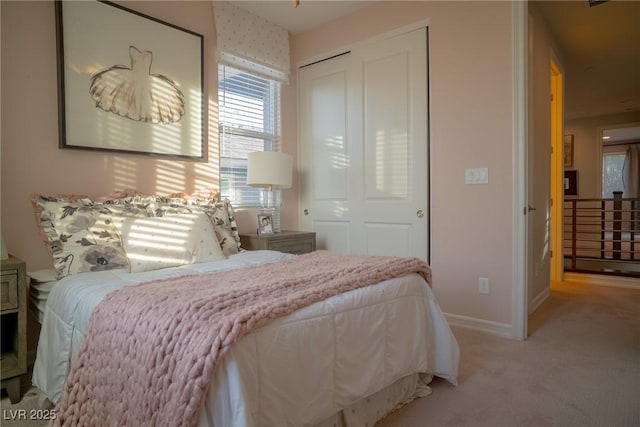 bedroom featuring light carpet and a closet