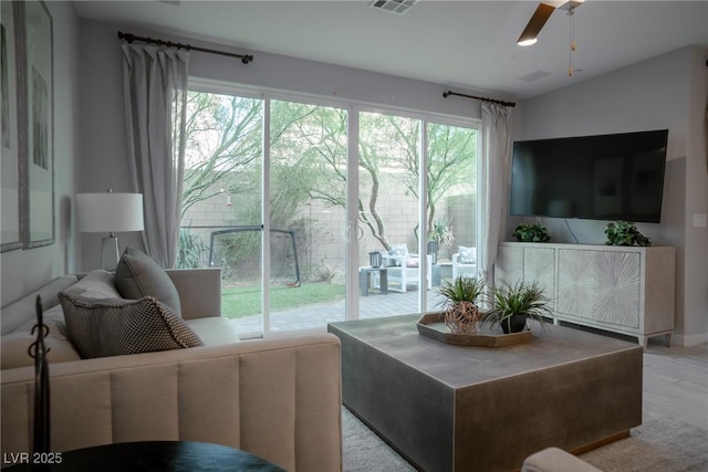 living room with ceiling fan and light hardwood / wood-style floors