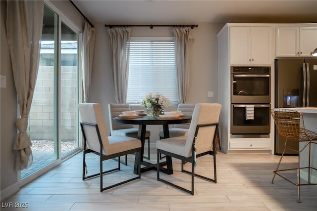 dining space with light wood-type flooring