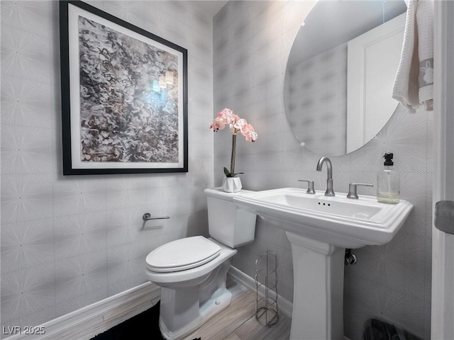 bathroom featuring tile walls, toilet, and hardwood / wood-style floors