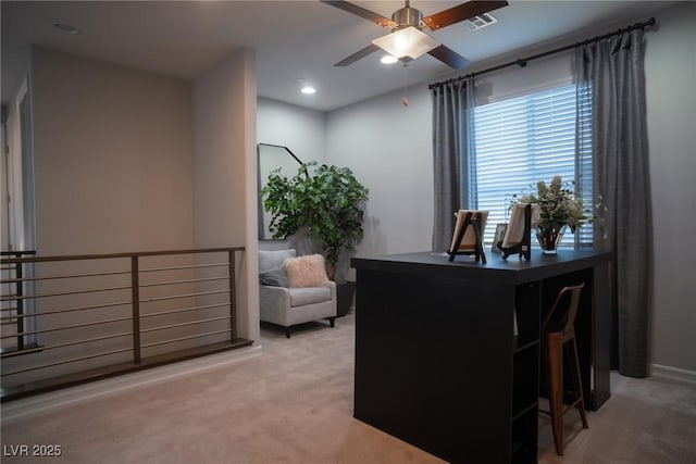 carpeted office with ceiling fan