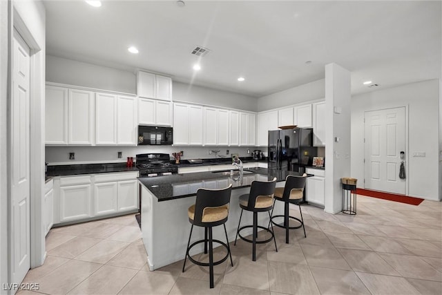 723 Orange Plume Walk Unit 0, Henderson, NV 89011 - kitchen with visible vents, recessed lighting, white cabinetry, light tile patterned floors, and black appliances