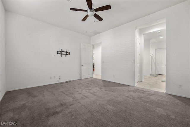 empty room with ceiling fan and light carpet