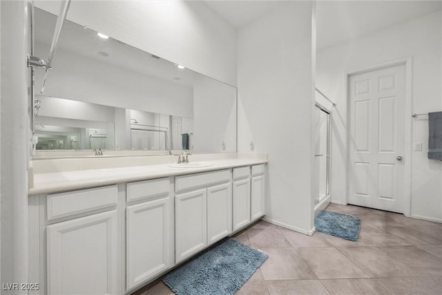 bathroom with vanity, an enclosed shower, and tile patterned flooring