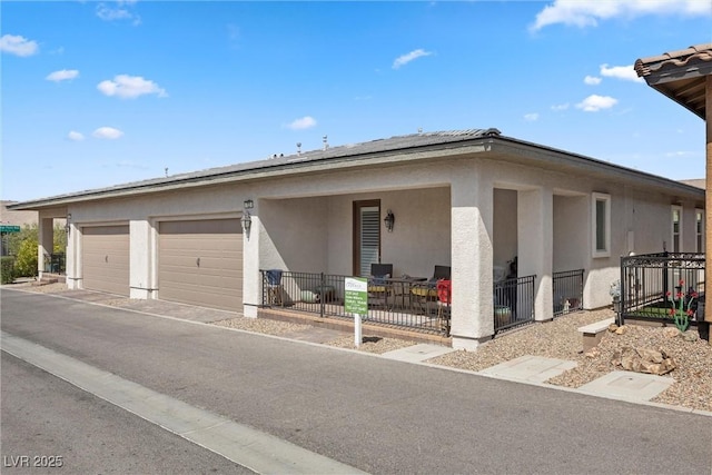 723 Orange Plume Walk Unit 0, Henderson, NV 89011 - view of front of property with an attached garage, aphalt driveway, and stucco siding