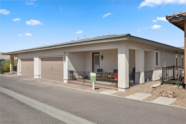 723 Orange Plume Walk Unit 0, Henderson, NV 89011 - view of front of property with stucco siding, an attached garage, and driveway