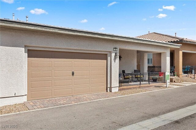 723 Orange Plume Walk Unit 0, Henderson, NV 89011 - view of front of house featuring stucco siding, an attached garage, and driveway
