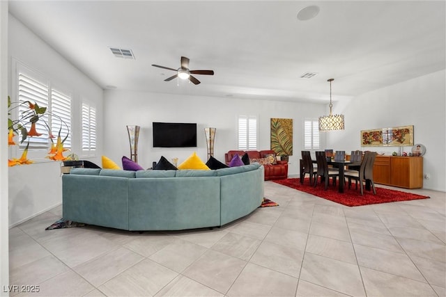 living room with ceiling fan and light tile patterned floors