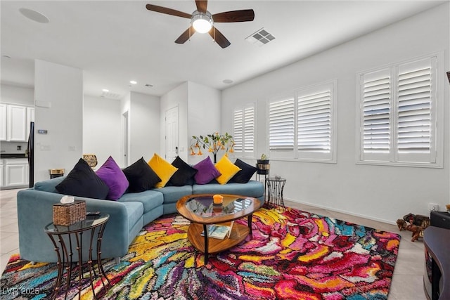 living room with light tile patterned floors and ceiling fan