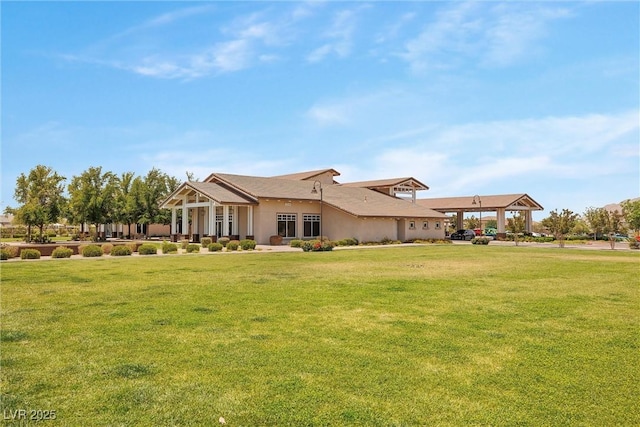 rear view of property featuring a yard