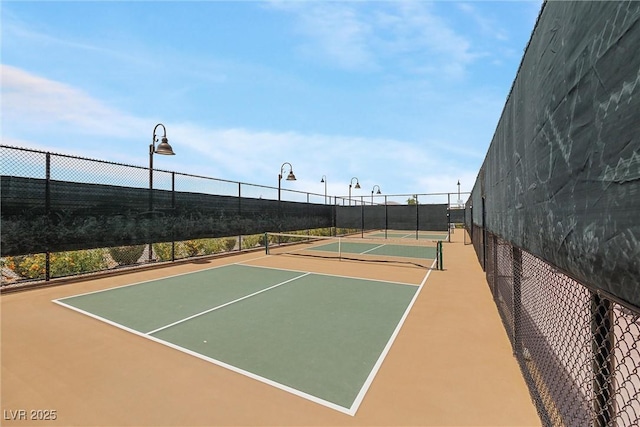 view of tennis court with basketball hoop